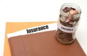 SUM Insurance policy in a folder on a table with a jar of coins