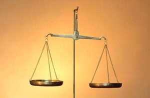 gold scale in front of a yellow background