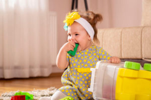 Child Chewing On Toy